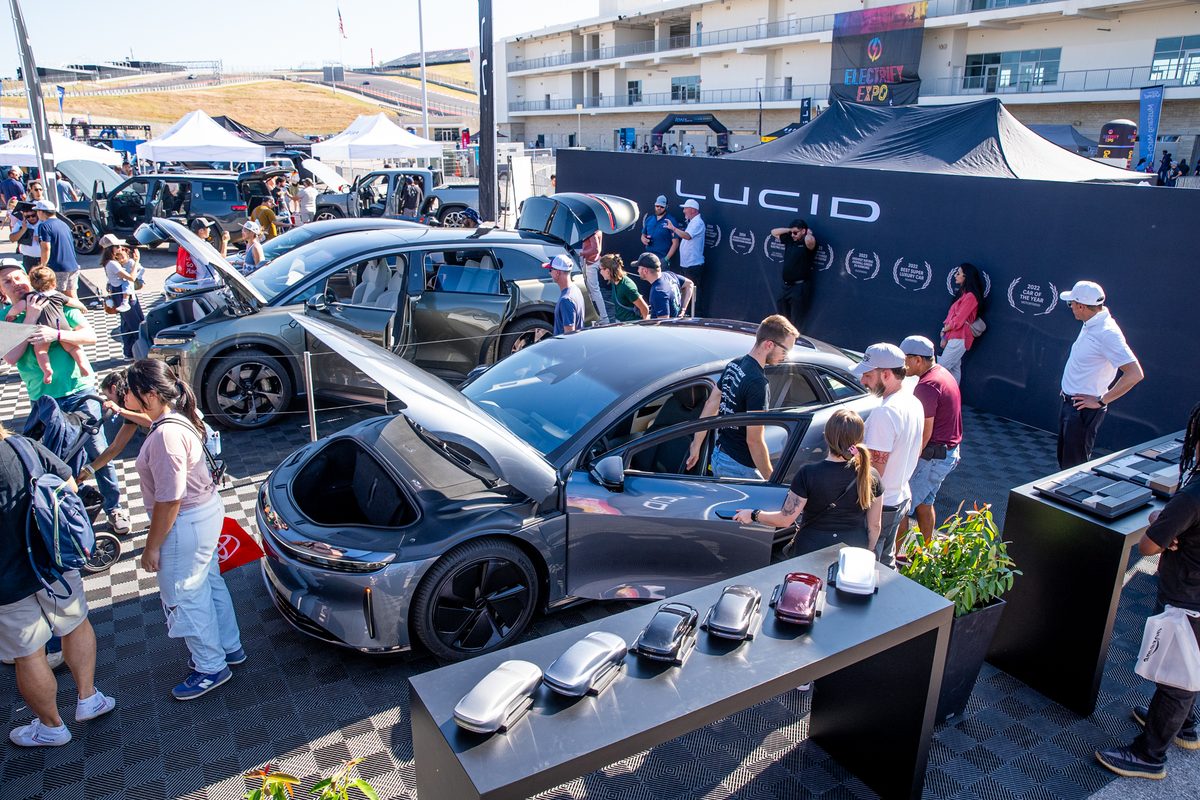 Lucid Air and Gravity EVs on display at the Lucid booth at Electrify Expo Austin with attendees exploring the vehicles