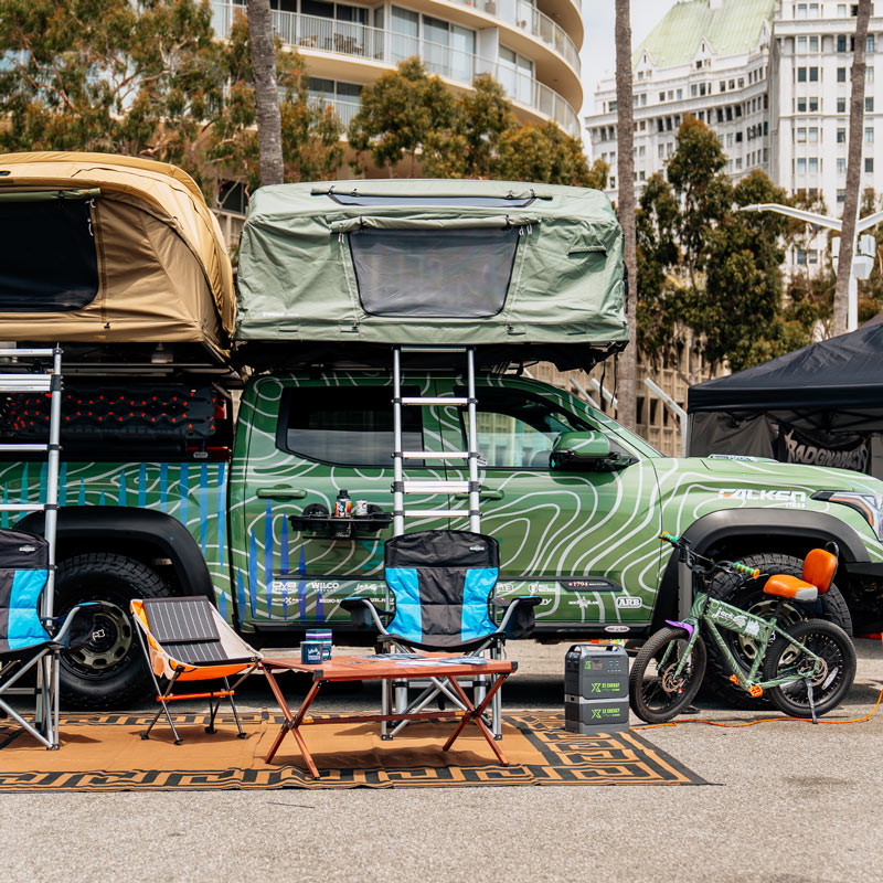 Camper van with rooftop tent and outdoor furniture