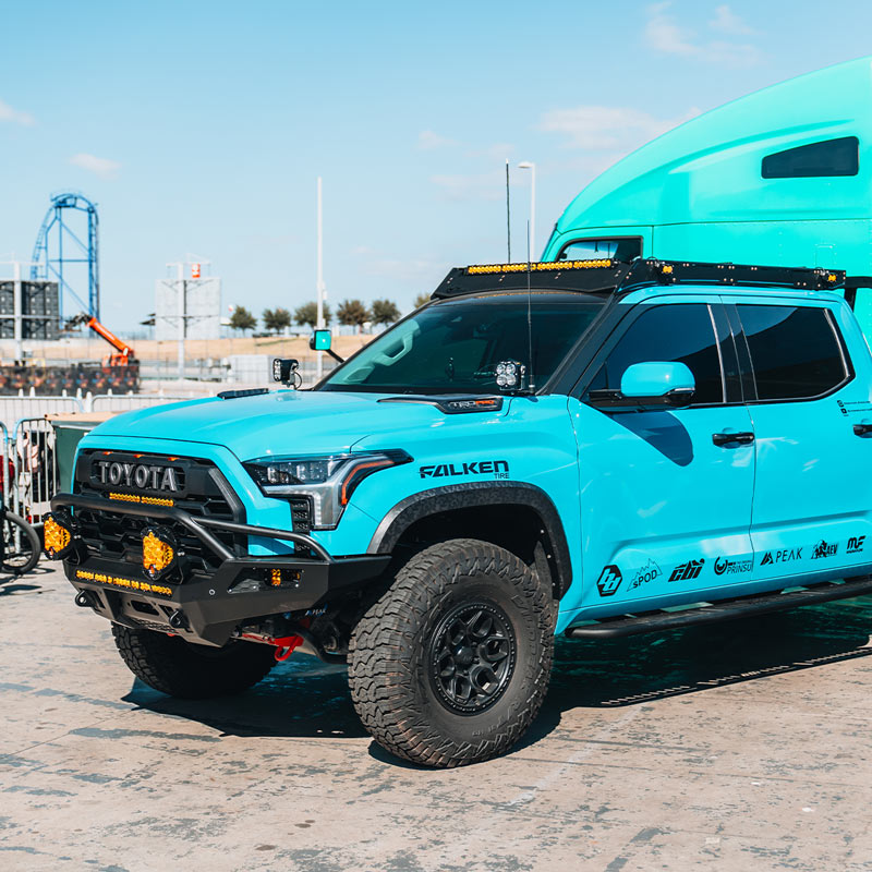 Blue Toyota truck with off-road equipment.