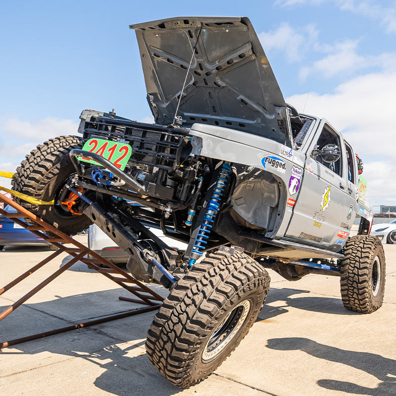 Off-road vehicle with lifted suspension and large tires.